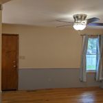 Dining room has access to garage on the left and you can see the fenced back yard through the window on the right.