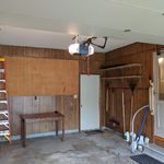 Door to backyard in middle of picture.  Human door to dining room on the right.  Extremely quiet Chamberlain garage door opener overhead which is wonderful for those times when it is raining or snowing.