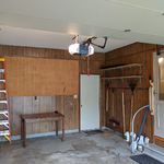 Door to backyard in middle of picture.  Human door to dining room on the right.  Extremely quiet Chamberlain garage door opener overhead which is wonderful for those times when it is raining or snowing.