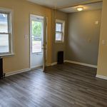 Living room looking towards front door. Kitchen area to right of front door