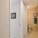 Hallway leading to office on the left with hall bathroom ahead to the right.  Laundry is to the right.  There is a sliding pocket door that closes off this entire area for privacy if needed.

Looking South.