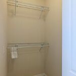 Primary bedroom walkin closet.  Shelving to hold your clothes.

Looking North.