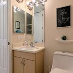 Hall bath with sink.  Medicine cabinet on the wall.

Looking East.